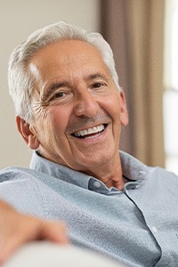 man smiling after getting implants