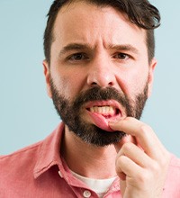 man showing off red inflamed gums 