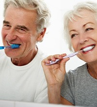 older couple brushing teeth together 